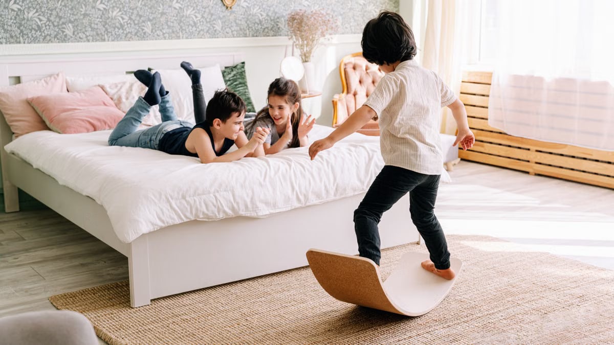 Group of children enjoying playful activities on a sunny day indoors.